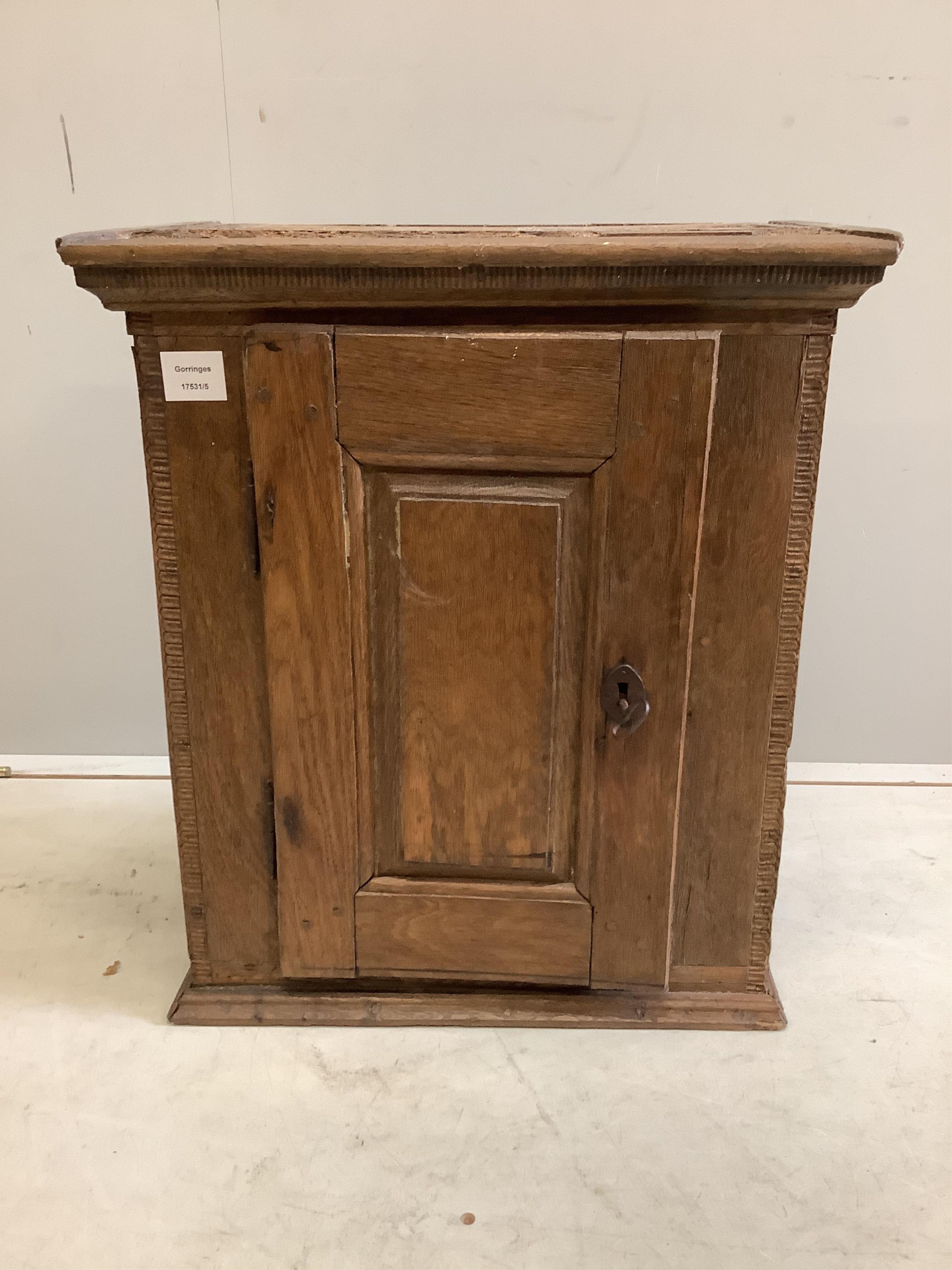 A small oak cupboard, width 51cm, depth 31cm, height 59cm